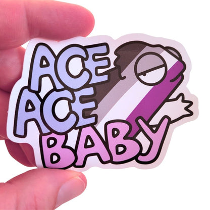 Sticker with 'ACE ACE BABY' text and an asexual chameleon held by a hand