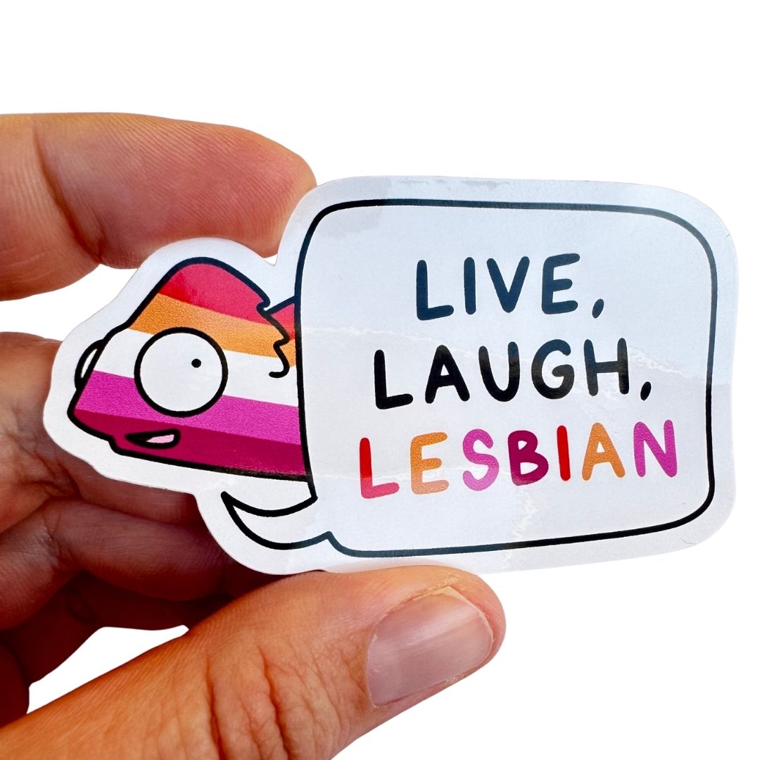 Sticker with 'Live, Laugh, Lesbian' text held by a hand