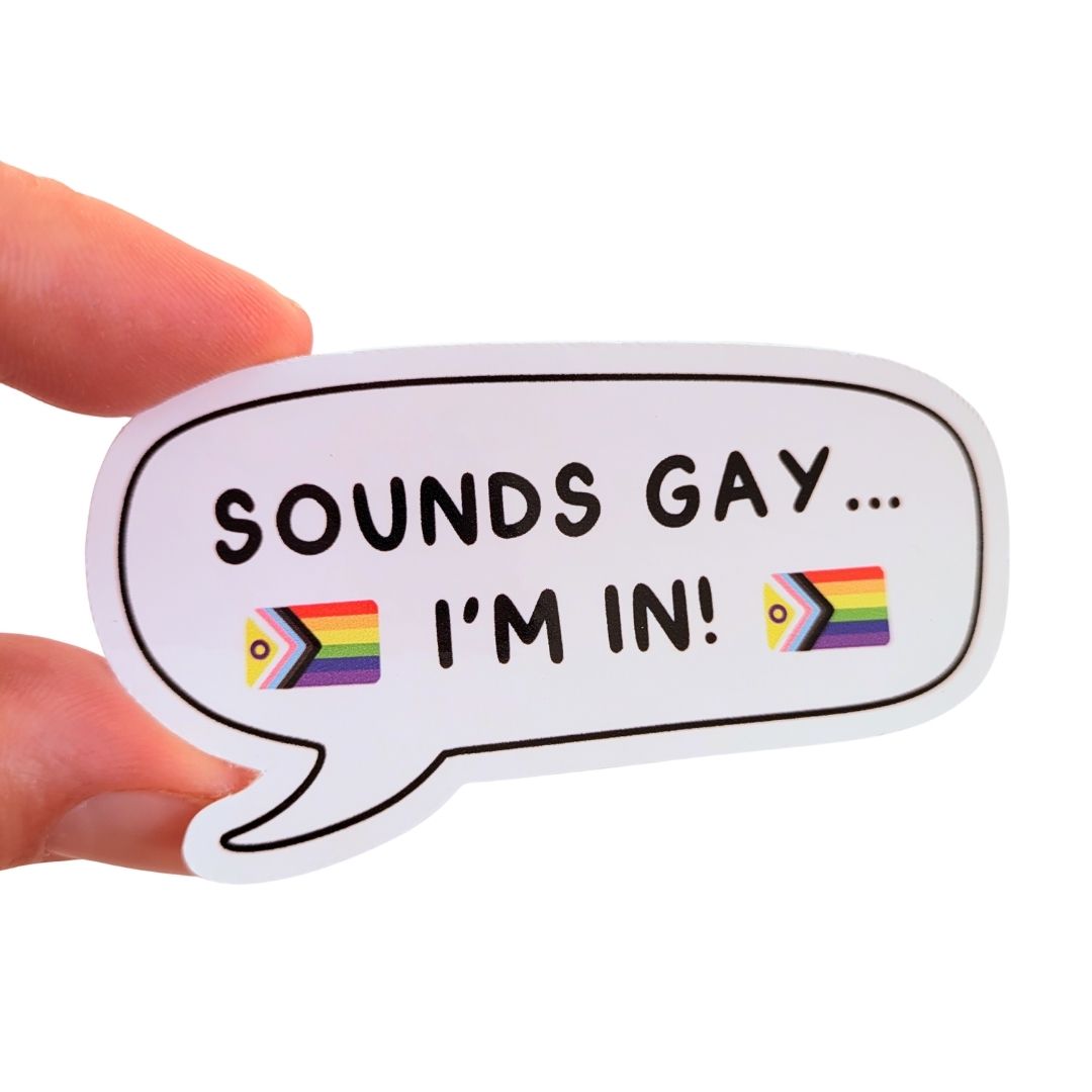 Sticker with text 'SOUNDS GAY... I'M IN!' held by a hand on a white background