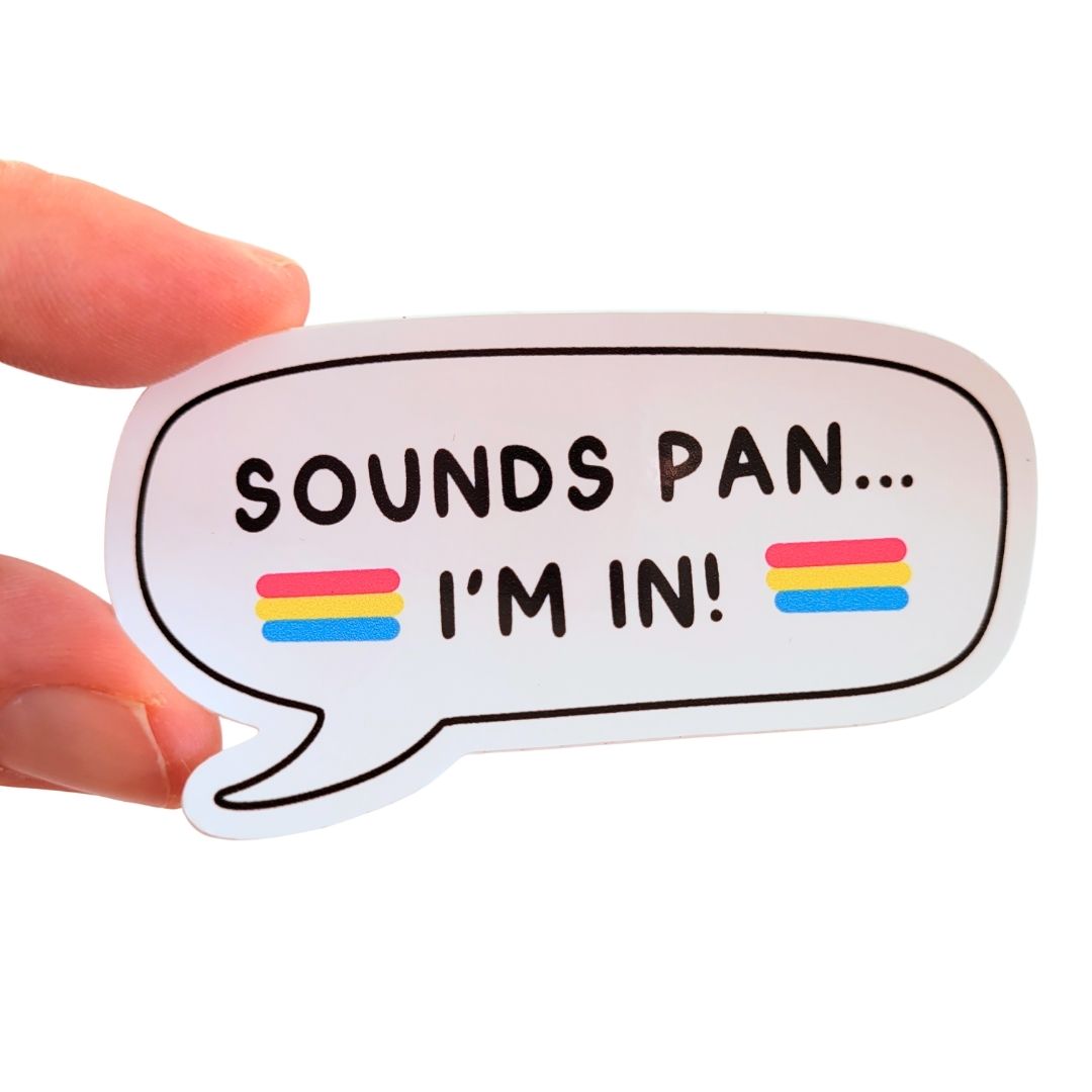 Speech bubble sticker with 'SOUNDS PAN... I'M IN!' text and pansexual flags held by a hand on a white background