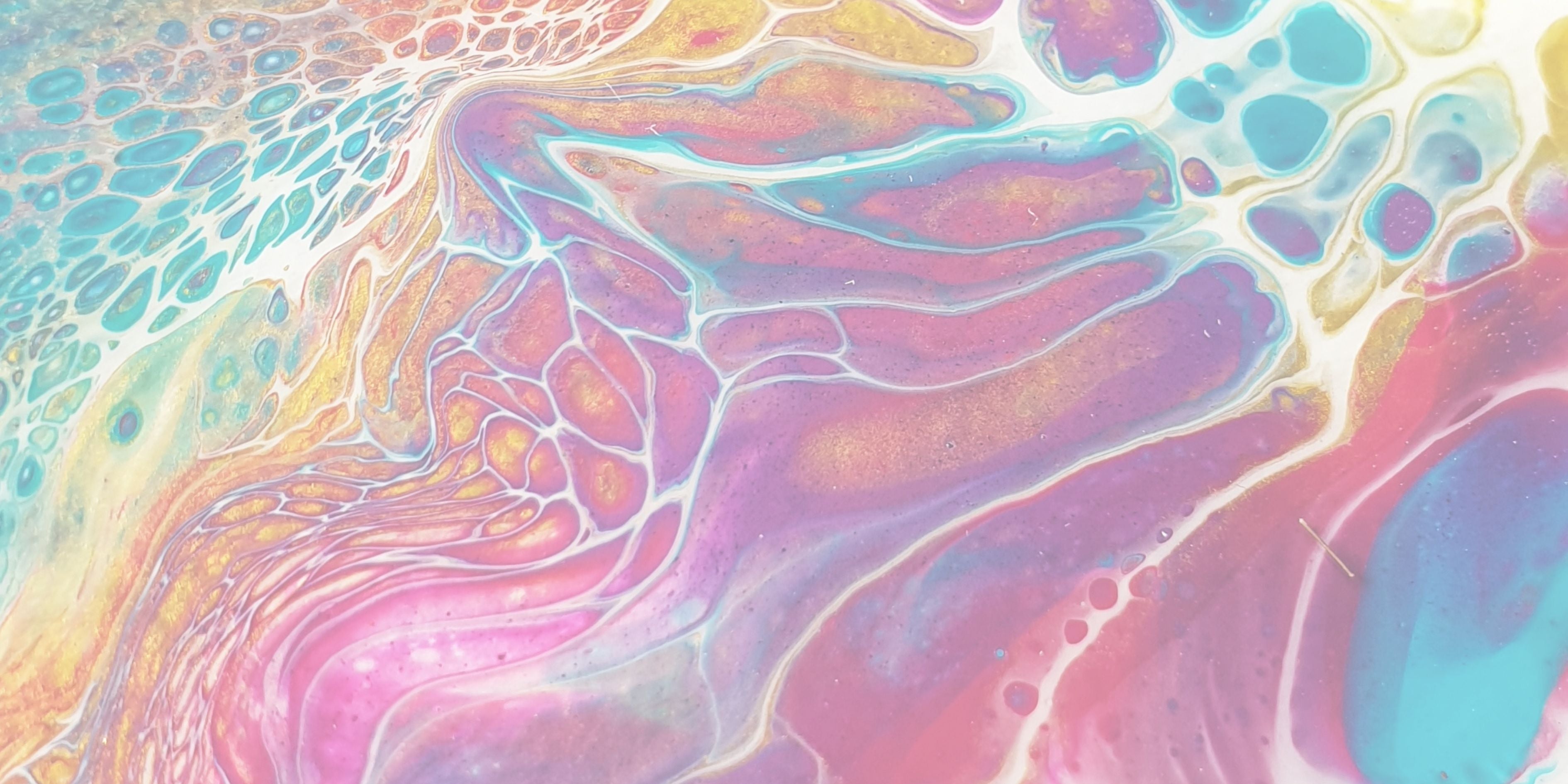 Colorful abstract pattern with pastel shades of pink, blue, and yellow.