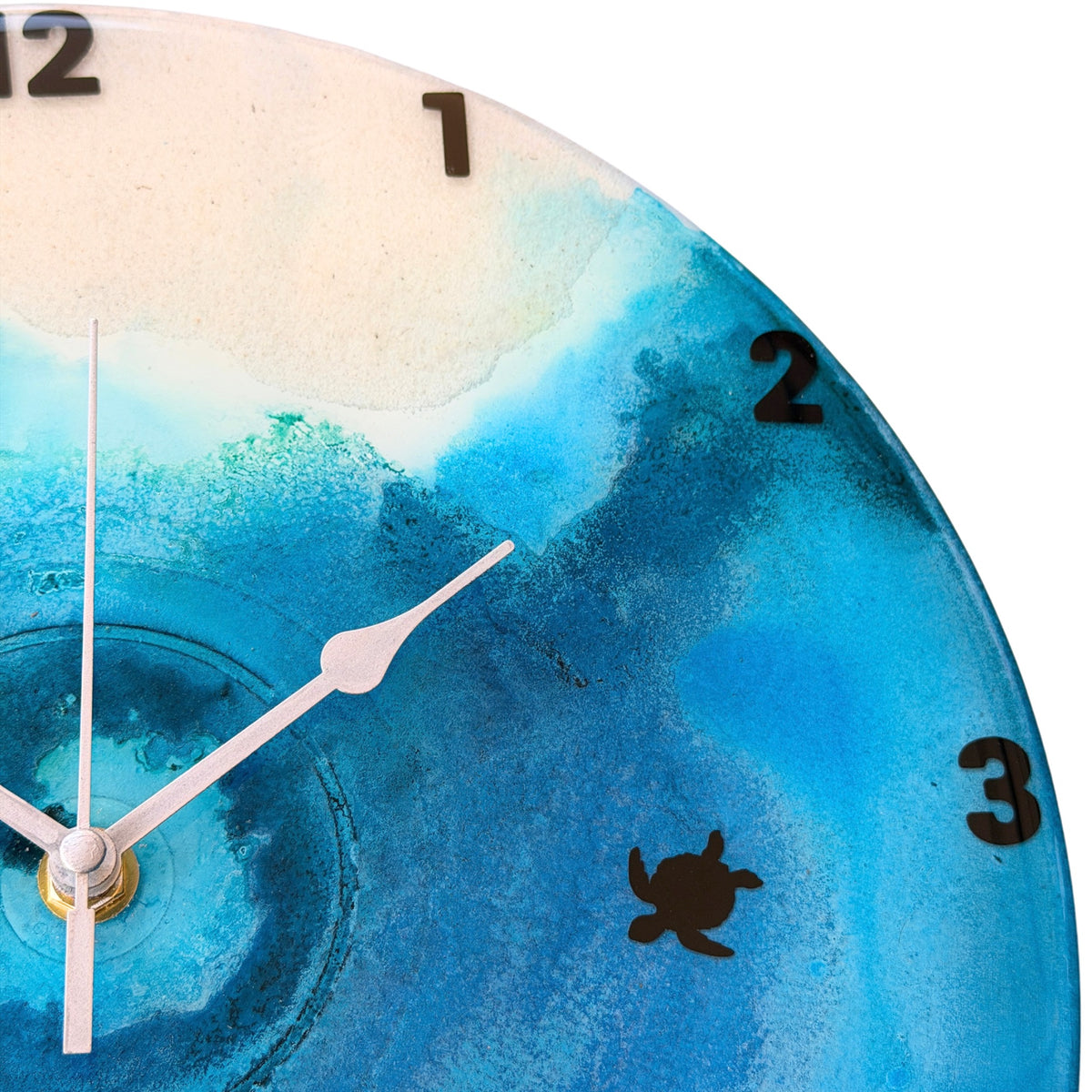 A beach coloured clock with black numbers and turtles